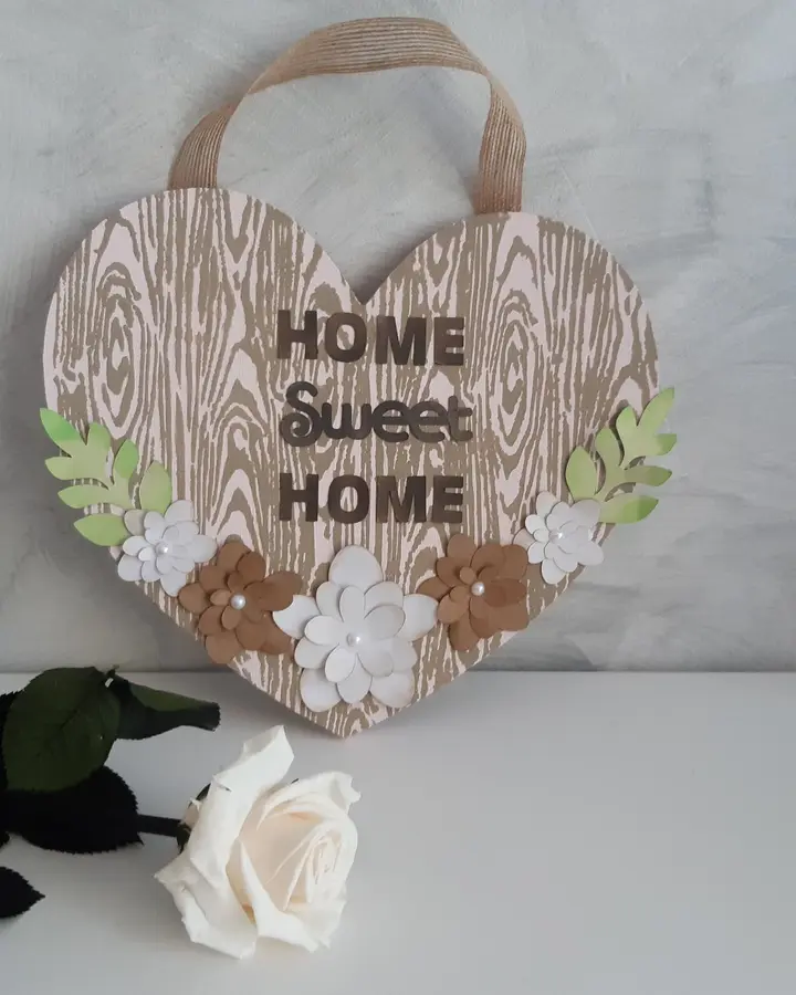 Corazón de madera pintado en rosa con flores de papel y texto Home Sweet Home