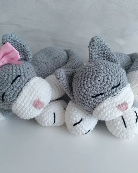 Pareja de gatitos amigurumi grises dormidos con lazos, tejidos a crochet